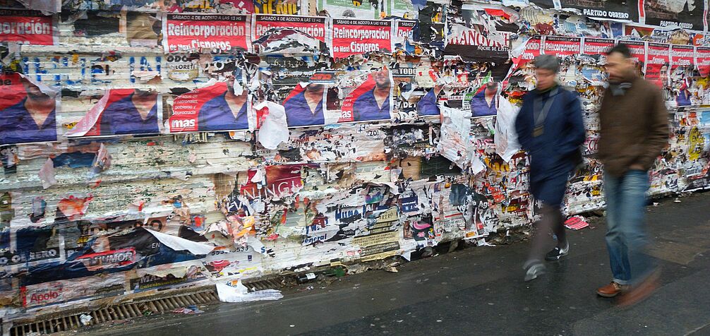 security blinds covered in posters in Buenos Aires